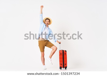 handsome man with red suitcase self confidence lifestyle joy of leisure