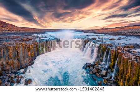 View from flying drone of Selfoss Waterfall. Awesome summer sunrise on Jokulsa a Fjollum river, Jokulsargljufur National Park. Colorful morning scene of Iceland, Europe. 
