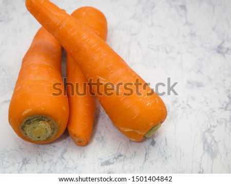 Carrots placed on white marble