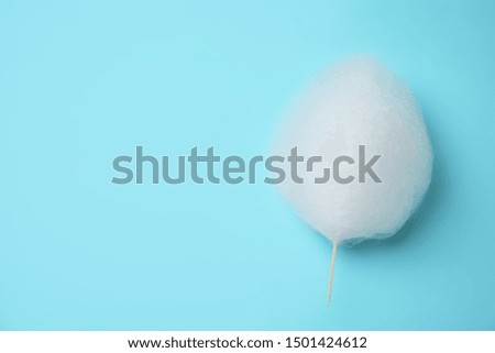 Sweet cotton candy on light blue background, top view. Space for text