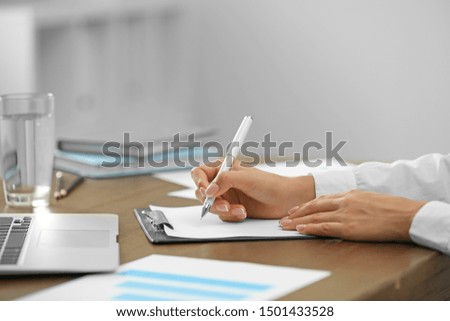 Business trainer working at table in office, closeup