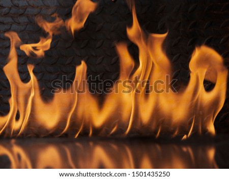 The flame on the background is a metal plate with a shadow of the flame.