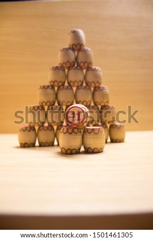 Pyramid of lotto barrels on an orange background. The game is Russian lotto.