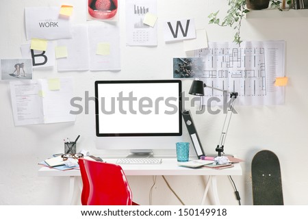 Modern creative workspace with computer and red chair. The office of a creative worker. Royalty-Free Stock Photo #150149918