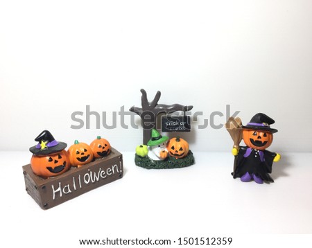 Pumpkin head dolls are on the white paper