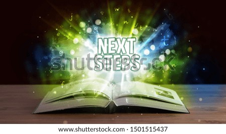 NEXT STEPS inscription coming out from an open book, educational concept