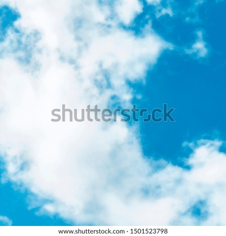 Abstract background, design template with copyspace. Vibrant blue sky with soft white clouds