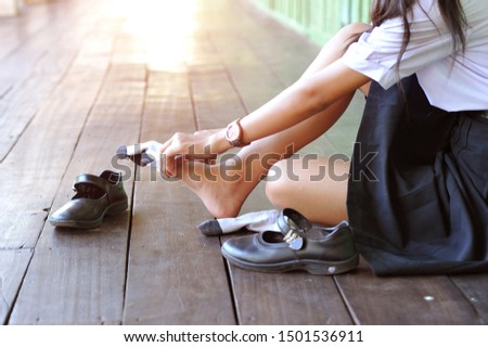 
 feet of female students wearing black student shoes