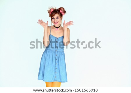 Portrait of a cute happy funny blonde girl with colored hair in a funny dress on a white background. Smiling in various poses, beauty, holiday.