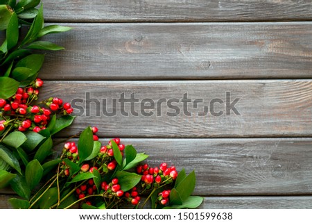 Summer pattern with green plants and red berries on wooden background top view mockup
