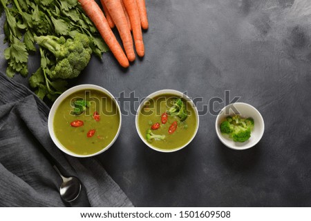  Healthy Vegan Creamy blended vegetable Soup puree with broccoli, celery, peas and carrots . Green detox  soup concept. Low-fat lunch.