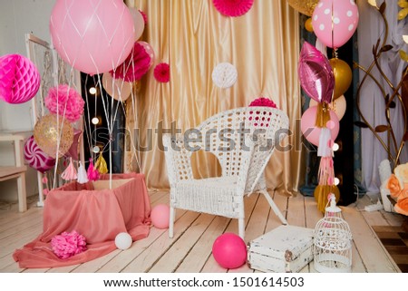 Interior of a living room with chair, balloons and flowers. Interesting location for the photo shoot in pink colour. Part of beautiful Living Room in Home