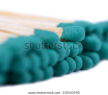Matches with a green head. Closeup with shallow DOF. Isolated on white background.