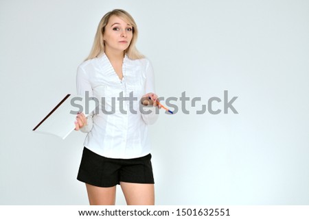 Portrait of a pretty blonde manager girl in a white blouse on a white background with a folder in her hands. Right in front of the camera in various poses.