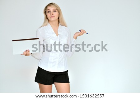 Portrait of a pretty blonde manager girl in a white blouse on a white background with a folder in her hands. Right in front of the camera in various poses.