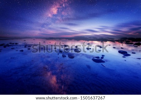 milky way galaxy rise above sea. image contain soft focus and noise.