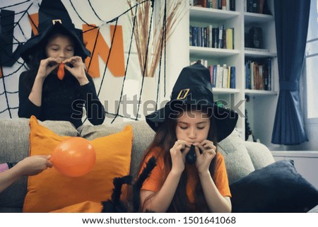 Halloween party kids smiling happy to play and prepare decoration toy balloon for Halloween day coming soon in living room at home together