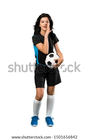 A full-length shot of a Young football player woman whispering something over isolated white background