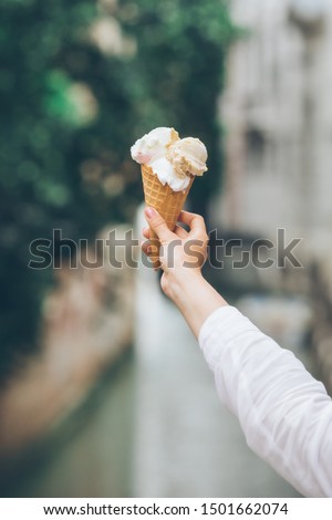 ice cream in woman hand outdoors