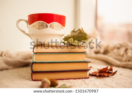 Autumn still life with books and a coffee mug. Homeliness