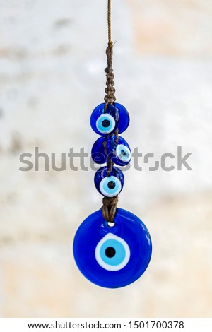 Blue evil eye / nazar boncuğu, Turkish symbols hanging on a tree