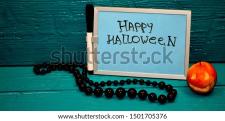 Beautiful turquoise background, a board with the inscription halloween ...