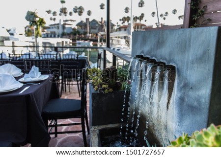 Soothing sounds from the water fountain in the outdoor seating patio along waterfront canal.