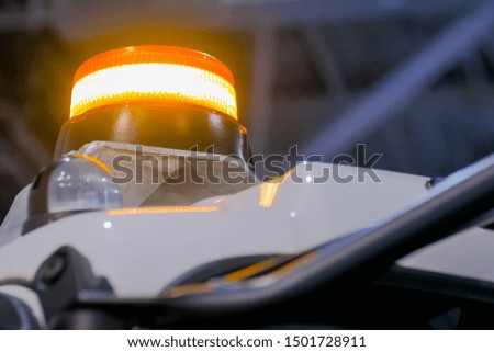 Close up of warning orange beacon flashing on roof of emergency, support and service vehicle. Danger, legal, alert light, attention and hazard concept
