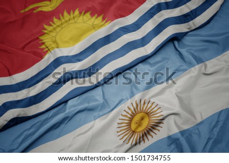 waving colorful flag of argentina and national flag of Kiribati . macro