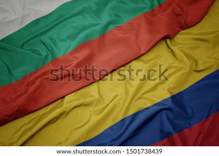 waving colorful flag of colombia and national flag of bulgaria. macro