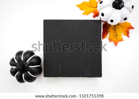 Blank black quote block sign with pumpkin decor on white background, wood sign halloween mockup
