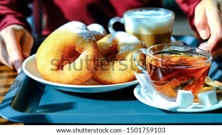 Doughnuts, tea and coffee, close-up of Breakfast on a tray. The concept of a morning Cup of coffee. Sweet, dessert, diet concept