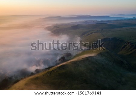 drone photo of hope valley and winnats pass at sunrise. taken from mam tor watching the inversion in the valley