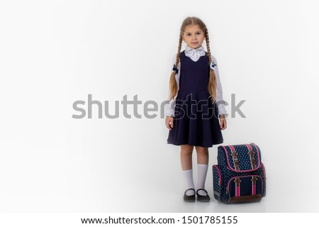 School girl posing for a picture cheerfully on white background