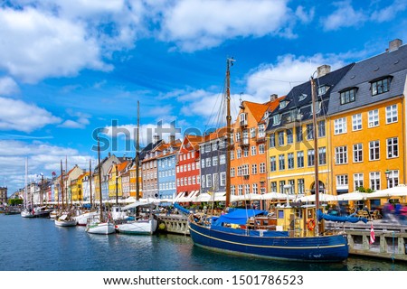 Scenic summer view of Nyhavn pier with colorful buildings and boats in Old Town of Copenhagen, Denmark Royalty-Free Stock Photo #1501786523