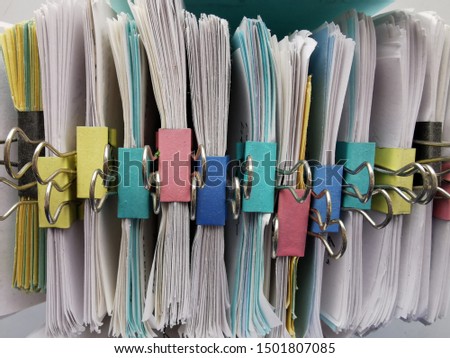 Small Square Sheets of Paper with a Curved Edges and Metal Binder Clips