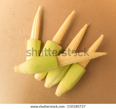 baby corn on brown paper background
