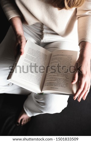 
girl sitting reads a book