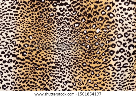 Background in the form of a knitwear product with a pattern similar to a leopard skin in cream brown tones
