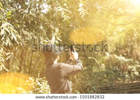 Asian woman take a picture at the outdoor