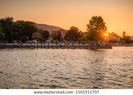 Beautiful sunset behind the famous lake of Ioannina, Greece. Sunset colors at lake Pamvotis boating to the small island. Epirus, Greece. Royalty-Free Stock Photo #1501911707
