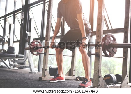 The young man who beginner training with barbell in gym. Fitness concept.Fitness muscular body. Royalty-Free Stock Photo #1501947443