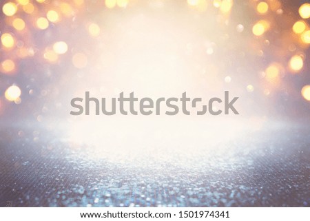 background of abstract glitter lights. silver, light blue and gold. de-focused.