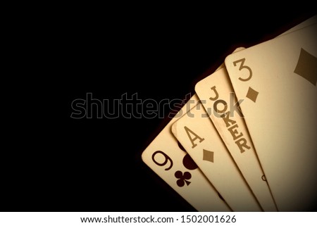 Playing cards on a dark background close up. Retro style