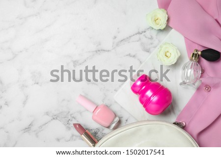 Flat lay composition with natural deodorant and cosmetics on white marble table, space for text