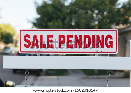 Sale Pending real estate sign by a newly listed house. Royalty-Free Stock Photo #1502018147