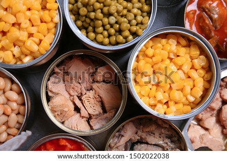Open tin cans of conserved products, top view Royalty-Free Stock Photo #1502022038
