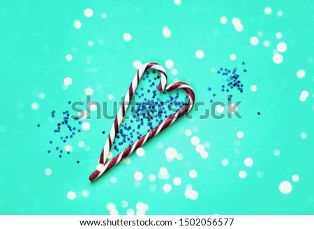 Caramel heart on mint pastel trendy background with sparkles. Festive backdrop for package and projects.  Sweetest Day. Close-up,copy space