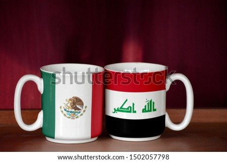 Iraq and Mexico flag on two cups with blurry background