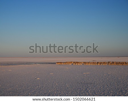 Abandoned remains of wooden structures on a salt lake
